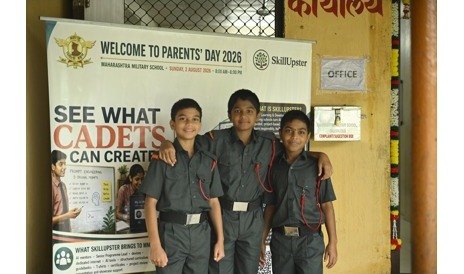 Three cadets beside the SkillUpster Parents' Day banner