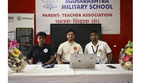 A presenter with students at the lectern