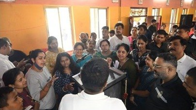 Parents and students gathered around a laptop demonstration