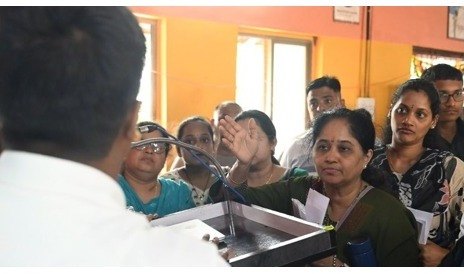 A presenter speaking with families at the event